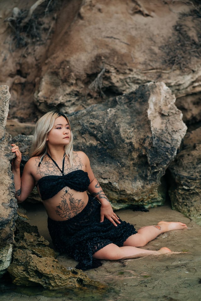 Tattooed siren at the beach chilling